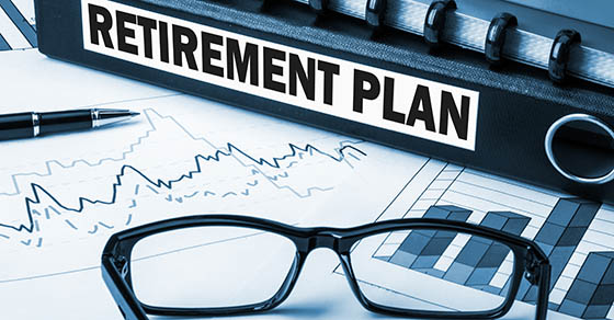 A tax-favored retirement plan sits on a table with a graph and pair of glasses